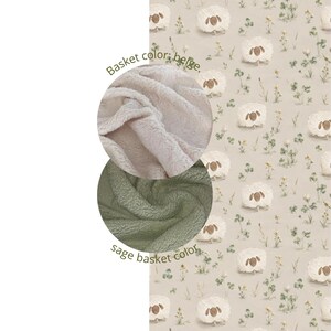 May include: A beige fabric featuring a repeating pattern of white sheep and small green plants. Two circular insets show textured fabric swatches: one in beige with the text "Basket color: beige." and one in sage green with the text "sage basket color."