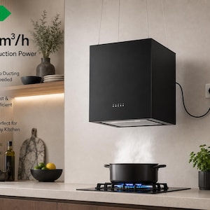 May include: A matte black cube-shaped kitchen range hood suspended from the ceiling above a stovetop. The unit features a power cord plugged into a wall outlet and displays text including A++, 800m³/h, and Strong Suction Power.