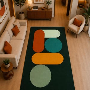 Modern rectangular area rug featuring deep green base with orange yellow mint and ivory shapes