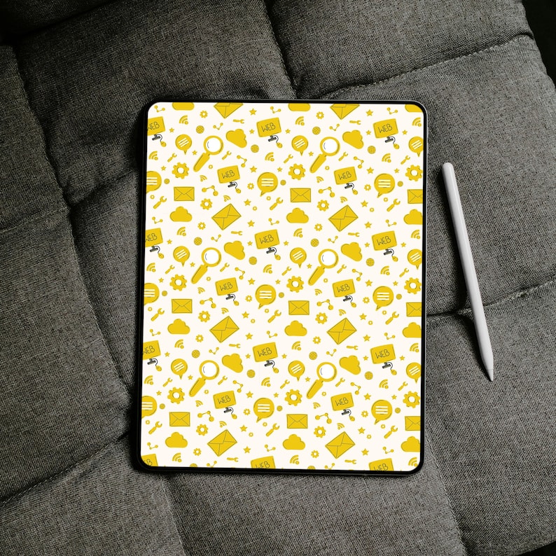 May include: A rectangular tablet featuring a white background with a repeating yellow pattern of web-related icons including magnifying glasses, envelopes, speech bubbles, gears, clouds, and the text WEB. A white stylus is positioned to the right.