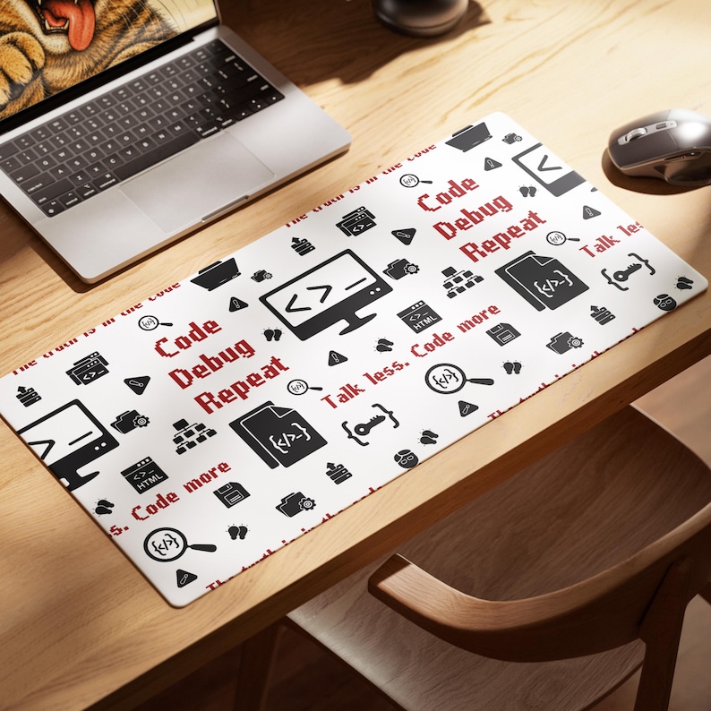 May include: A white rectangular desk mat featuring a repeating pattern of black computer-related icons and red text. The text includes the phrases Code Debug Repeat and Talk less. Code more. Icons include monitors, folders, and magnifying glasses.