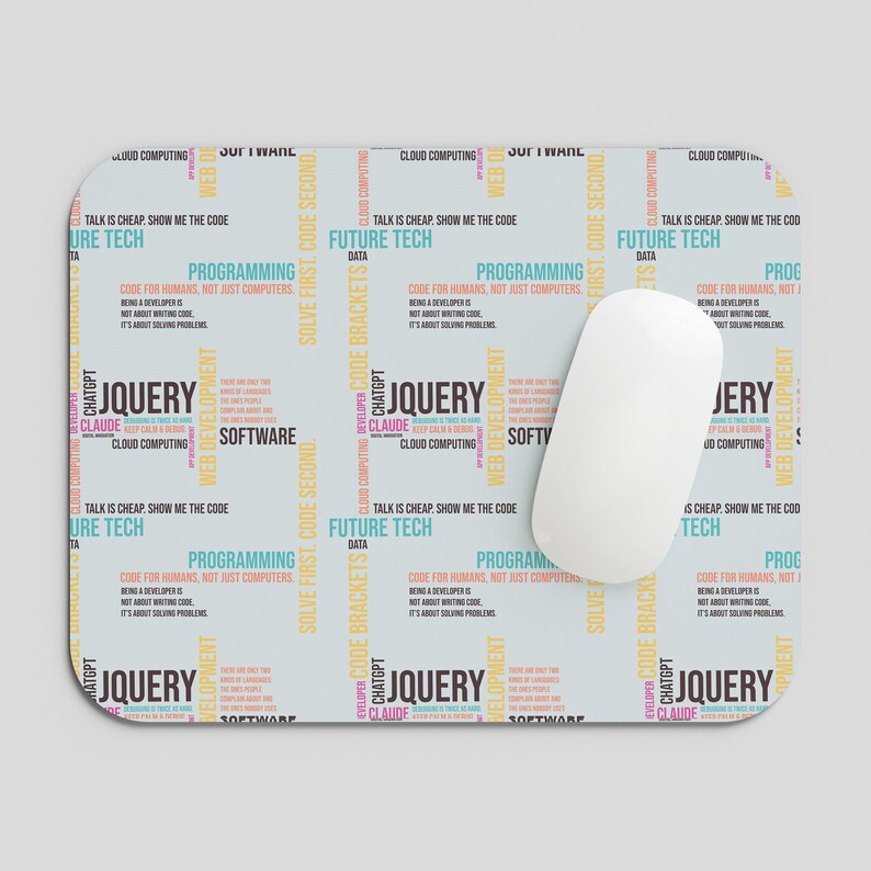 May include: A rectangular mouse pad with a light gray background featuring a repeating pattern of tech-related text in black, blue, yellow, and pink. The text includes phrases like JQUERY, FUTURE TECH, SOFTWARE, and TALK IS CHEAP. SHOW ME THE CODE.