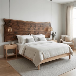 May include: A bedroom set featuring a large live-edge dark wood headboard mounted on a wall, a light wood bed frame with beige bedding, two white pillows, two small grey accent pillows, a light wood nightstand, and a matching armchair.