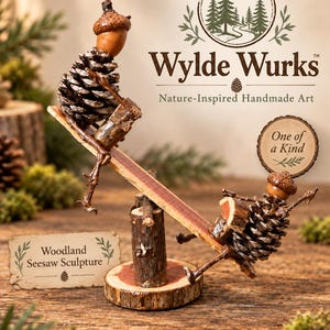 May include: A seesaw sculpture featuring two figures made from pinecones and acorns, balanced on a central wooden log base. The text Wylde Wurks Nature-Inspired Handmade Art, One of a Kind, and Woodland Seesaw Sculpture are visible in the image.