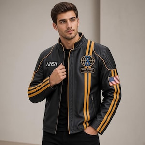 May include: A black leather jacket featuring yellow racing stripes, a NASA logo on the right chest, and a circular emblem with the text WARE PAIRRICA DARICLIPS on the left chest. The left sleeve displays a United States flag patch.