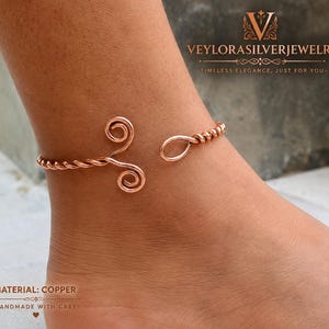 May include: A copper anklet featuring a twisted wire design with two spiral ends and a single loop closure. The jewelry is branded with the text VEYLORASILVERJEWELRY and includes the label MATERIAL: COPPER HANDMADE WITH CARE.