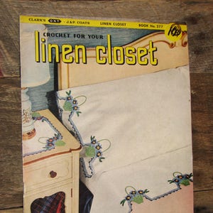 May include: A vintage book cover titled "Linen Closet" with the text "Crochet for Your Linen Closet" in yellow. The cover shows a bedroom scene with a bed and a nightstand. The bed linens have floral crochet edging.