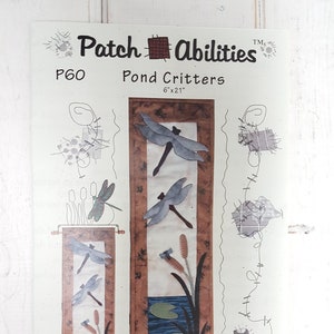 May include: A paper craft pattern titled "Pond Critters" by Patch Abilities. The design features dragonfly and pond scenes. The pattern measures 15 cm x 53 cm.