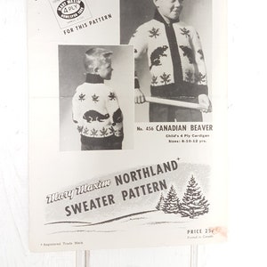 May include: A vintage Mary Maxim Northland sweater pattern. The pattern features a child's cardigan design with a Canadian beaver motif. The pattern includes a black and white photo of the sweater and the text "Canadian Beaver".