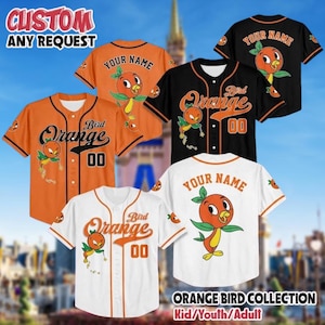 Puede incluir: Camisetas de béisbol personalizables en naranja, negro y blanco con un gráfico de Orange Bird, el texto "Bird Orange", el número "00" y "YOUR NAME" en la espalda. El texto "CUSTOM ANY REQUEST" y "ORANGE BIRD COLLECTION" es visible.