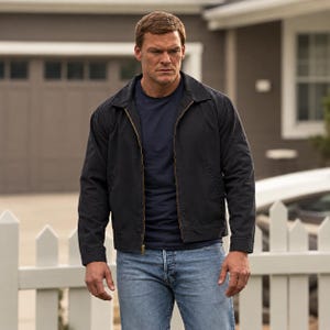 May include: A dark navy blue zip-up jacket with a collar, worn over a plain navy blue t-shirt and light blue denim jeans. The jacket features a gold-toned metal zip down the front, long sleeves with cuffs, and a simple, structured design.