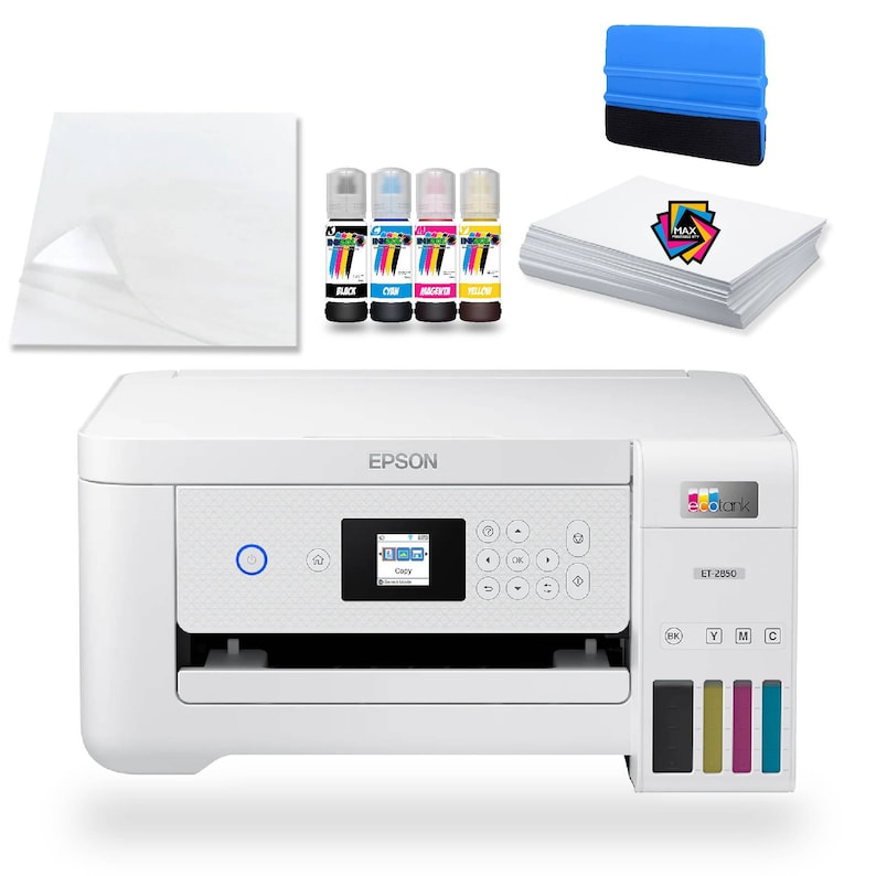 May include: White Epson EcoTank ET-2850 all-in-one printer with a colour touchscreen display. The printer has a separate ink tank system with black, cyan, magenta, and yellow ink bottles. The printer is on a white surface with a sheet of clear transfer paper, a stack of white paper, and a blue squeegee.