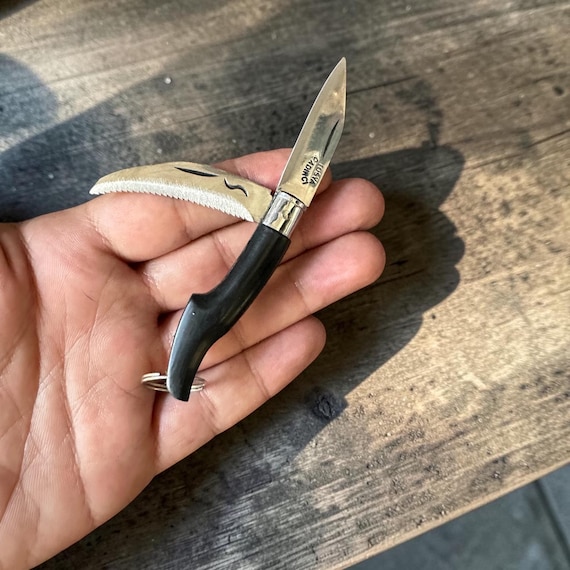 A miniature hand-forged Turkish Tosya knife keychain with genuine buffalo horn scales and a hidden pruning saw — a functional EDC micro-tool made by a traditional craftsman, not a factory.
