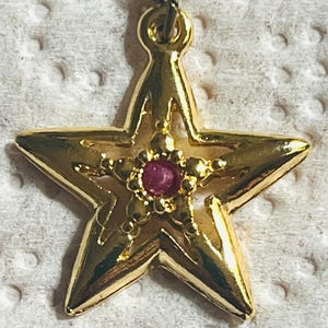 Vintage Star Necklace with Ruby signed JJI Gold tone charm with 18” chain