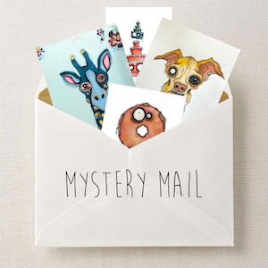 May include: A white envelope with the text "MYSTERY MAIL" in black, holding several art cards. The cards display illustrations of a giraffe, a dog, a donut, and a tiered cake, each with a distinctive, expressive style.