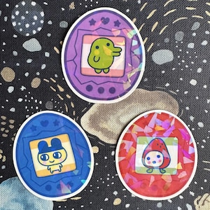 Adesivos holográficos Tamagotchi - Mametchi, Kuchipatchi e Ichigotchi