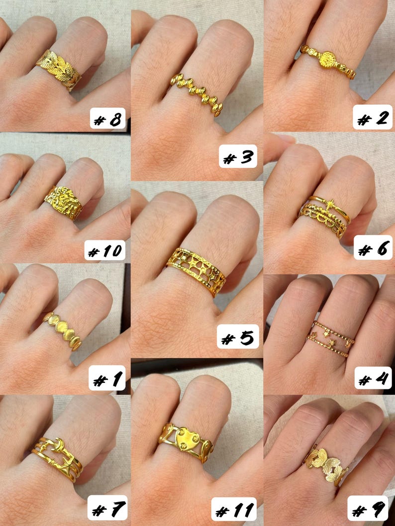 May include: A collection of eleven gold-toned rings displayed on fingers, featuring various designs including leaf patterns, star motifs, heart shapes, moon symbols, beaded textures, and openwork bands, each labelled with a corresponding number from one to eleven.