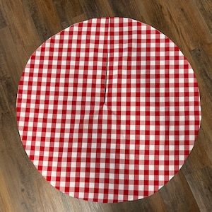 May include: Red and white gingham Christmas tree skirt with a slit in the center.