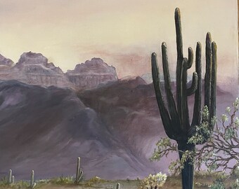 May include: A painting of a desert landscape with a tall, green cactus in the foreground. The cactus is in front of a mountain range in the background. The sky is a soft pink and purple.
