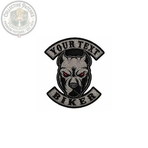 May include: An embroidered patch featuring a central grey dog head with piercing red eyes. The design includes two curved banners with black borders and silver glittery backgrounds. The top banner reads YOUR TEXT and the bottom banner reads BIKER.