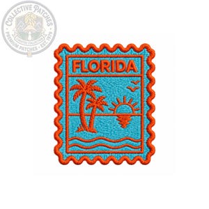 May include: A rectangular embroidered patch with a scalloped orange border and a light blue background. The design features the word FLORIDA in orange letters above a scene with two orange palm trees, a rising sun, and two birds in flight.