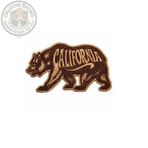 May include: A brown embroidered patch in the shape of a grizzly bear walking towards the left. The word CALIFORNIA is stitched in a light tan thread across the body of the bear, following the curve of its back with a decorative flourish underneath.