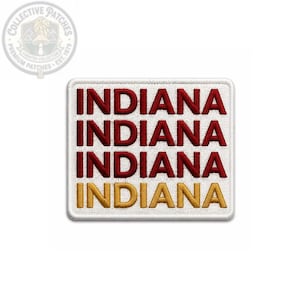 May include: A rectangular embroidered patch with a white background and a white border. The word INDIANA is stitched in red thread on the top three lines, and the word INDIANA is stitched in gold thread on the bottom line in a sans-serif font.
