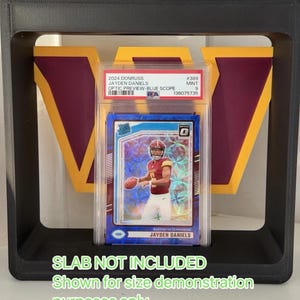 May include: A black 3D-printed display frame featuring a large yellow and burgundy 'W' logo in the background. The frame is designed to hold a graded sports card slab, which is visible in the centre. Text on the image reads: SLAB NOT INCLUDED Shown for size demonstration purposes only.
