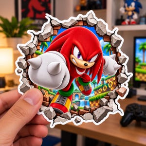 May include: A die-cut sticker featuring the red character Knuckles from the Sonic the Hedgehog series, depicted as if breaking through a brick wall. The character has large white gloves with spikes, red fur, and is set against a green landscape.