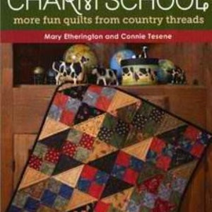 May include: Book cover with the title "Back to Charm School: More Fun Quilts from Country Threads" by Mary Etherington and Connie Tesene. The cover features a colorful quilt with a patchwork design.