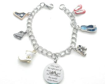 May include: Silver charm bracelet featuring shoe-themed charms, including ice skates, a boot, ballet flats, and sneakers. A round charm with the quote "Give a girl the right pair of shoes and she can conquer the world!" is also included.