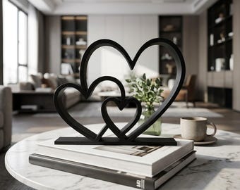 Modern interlocking heart table sculpture, matte black and white minimalist decor, small romantic shelf accent