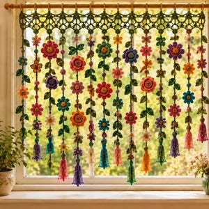 May include: A decorative window hanging featuring multiple vertical strands of crocheted flowers in vibrant colors including pink, orange, blue, and purple, accented with green leaves and finished with small tassels at the bottom of each strand.