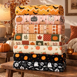 May include: A stack of seven folded fleece blankets featuring various autumn and Halloween patterns, including orange chevron with black bats, pink striped pumpkins, orange plaid, patchwork pumpkins, cream with orange pumpkins, black with jack-o'-lanterns, and black with ghosts.