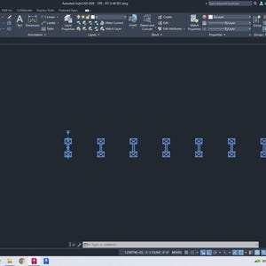 May include: A digital screenshot of the AutoCAD 2016 software interface displaying a dark gray workspace. Seven identical blue rectangular block references with internal cross-hatch patterns are arranged in a horizontal row across the center.
