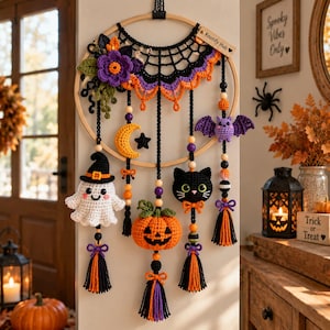 May include: A circular wooden hoop wall hanging featuring crocheted Halloween motifs including a white ghost with a black hat, an orange pumpkin, a black cat, a purple bat, a yellow crescent moon, and a black star, accented with beads and tassels.