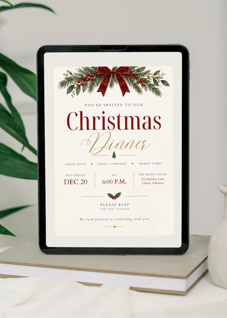 May include: A digital Christmas dinner invitation displayed on a tablet screen. The design features a red velvet bow, pine branches, and holly berries at the top. Text includes: You're invited to our Christmas Dinner, Dec 20, 6:00 P.M.