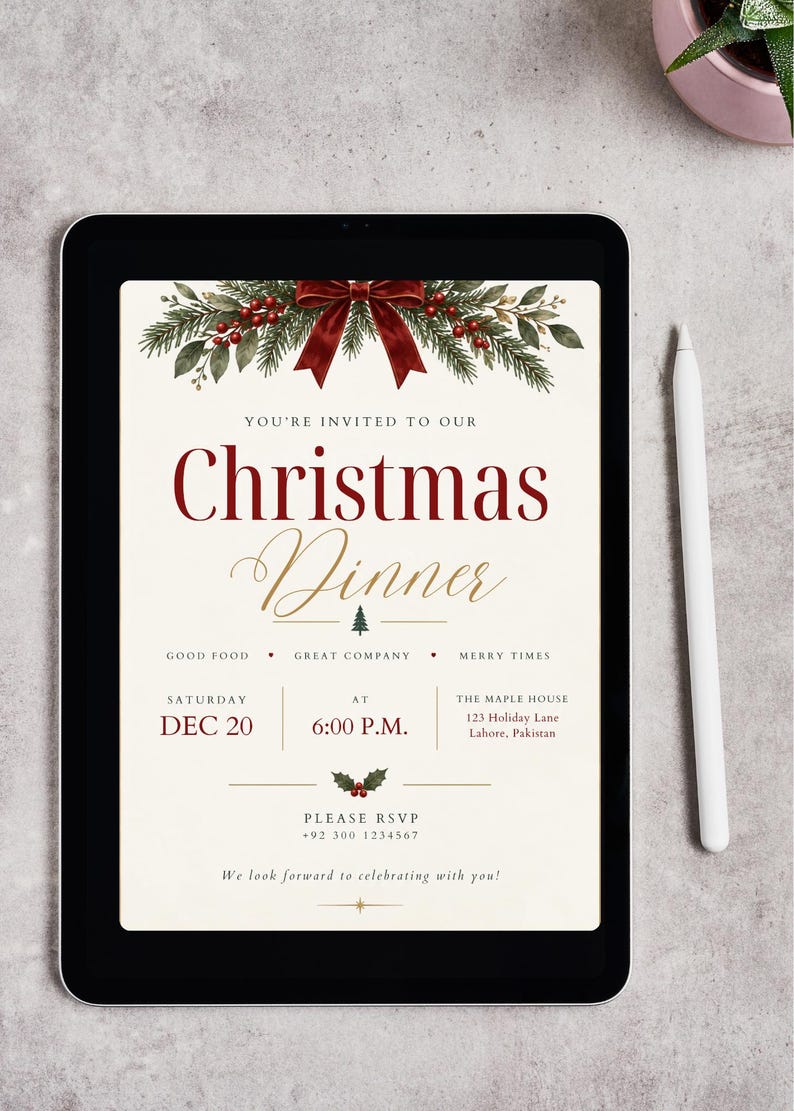 May include: A digital tablet displaying a Christmas dinner invitation with a cream background, red bow, and pine branch graphics. The text reads: You're invited to our Christmas Dinner, Saturday Dec 20, 6:00 P.M., The Maple House, 123 Holiday Lane, Lahore, Pakistan.
