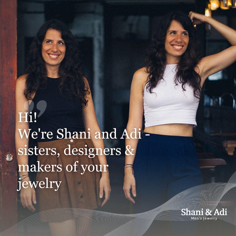 May include: Two women, sisters and designers, stand in front of a doorway. They are smiling and looking at the camera. The text "Hi! We're Shani and Adi - sisters, designers & makers of your jewelry" is displayed on the image. The text "Shani & Adi Men's Jewelry" is displayed at the bottom of the image.