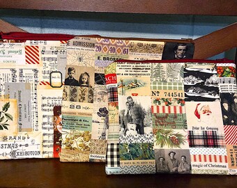 May include: Three rectangular fabric pouches with red zips, decorated with a collage of vintage ephemera. The designs include sheet music, old photographs, and Christmas-themed imagery. The pouches are likely for storage or organisation.