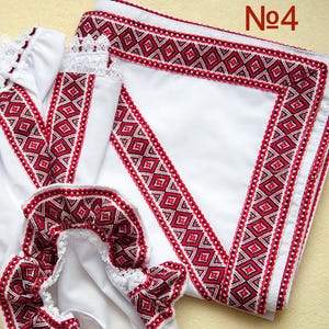 May include: White fabric items with red and black geometric embroidery. The embroidery features a diamond pattern. The items include a garment with lace trim and a folded square of fabric. The number "No4" is in the upper right corner.