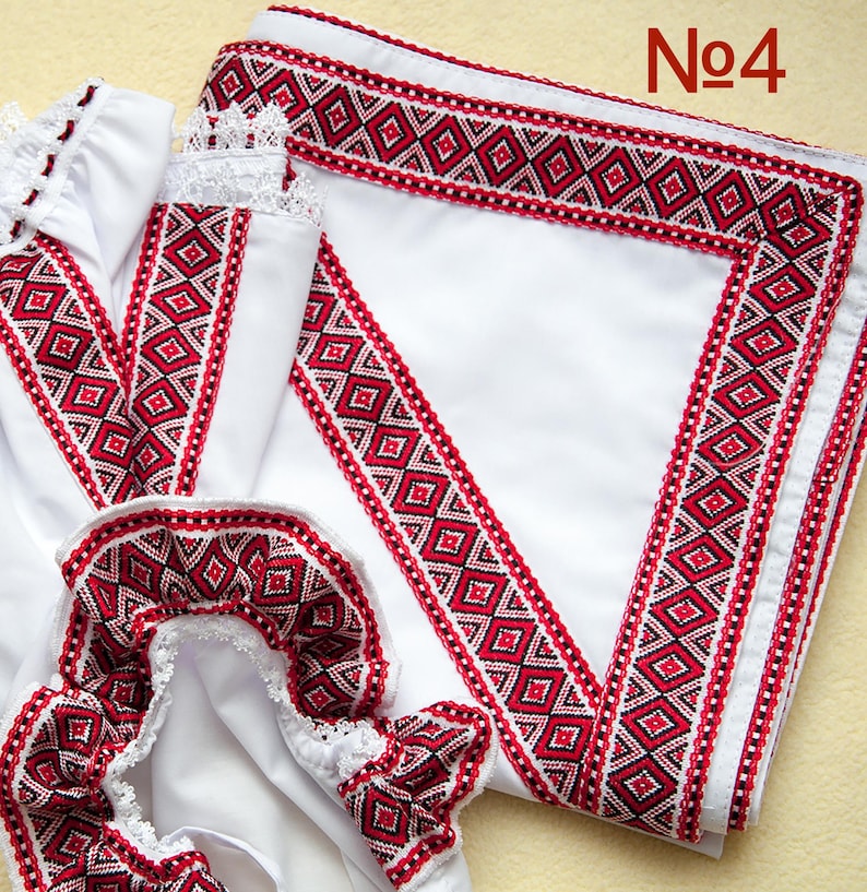 May include: White fabric items with red and black geometric embroidery. The embroidery features a diamond pattern. The items include a garment with lace trim and a folded square of fabric. The number "No4" is in the upper right corner.