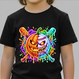 May include: A black short-sleeved t-shirt featuring a graphic print of a split pumpkin and baseball design. The image shows a glowing orange jack-o'-lantern on one side and a white baseball on the other, crossed by two baseball bats with colourful paint drips.