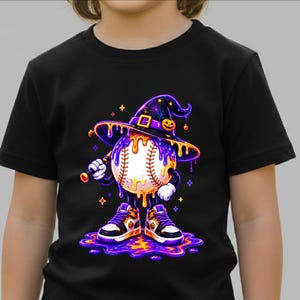 May include: A black short-sleeved t-shirt featuring a graphic of a baseball character wearing a purple witch hat and trainers. The baseball is covered in dripping orange slime, holding a baseball bat, and standing in a puddle of purple and orange liquid.