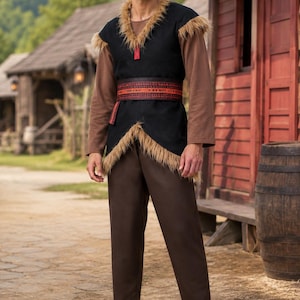 May include: A brown long-sleeved shirt and matching trousers paired with a black sleeveless tunic featuring tan faux fur trim along the neckline and hem. A wide dark red belt with intricate black geometric patterns is worn over the tunic.