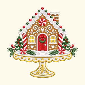 May include: An embroidered gingerbread house design on a gold pedestal cake stand. The house features a red door with a wreath, white icing details, peppermint candies, and two small green pine trees with red berries on a snowy base.