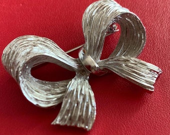 broche arc vintage des années 1950