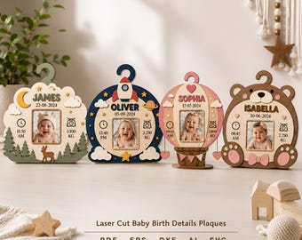 May include: Four decorative wooden plaques featuring baby birth details including names, dates, times, and weights in kilograms. Each plaque has a central photo frame and unique shapes: a forest scene, a rocket ship, a hot air balloon, and a bear.