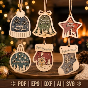 May include: Six wooden holiday ornaments hanging by twine. Shapes include a beanie with 'Happy New Year', a bell with 'Season's Greetings', a star with 'Happy Holidays', a round bauble with 'Warm Wishes', a mitten with 'Merry Christmas', and a stocking with 'Joy to the World'.