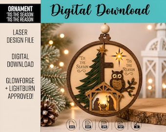 May include: A circular wooden ornament featuring a layered design with a green pine tree, a brown owl on a branch, and a nativity scene at the base. The text reads 'Tis the Season' and 'Tis the Reason' with a star above the owl. It includes a hanging bead.